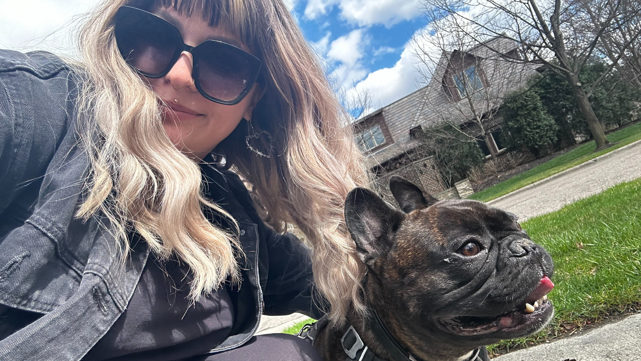 Olivia – Dedicated Dog Walker in Columbus, Ohio | Hands N Paws Team Spotlight Olivia, a dog walker from Hands N Paws, smiles while walking a happy dog on a leash in a Columbus park, demonstrating her commitment to excellent pet care.